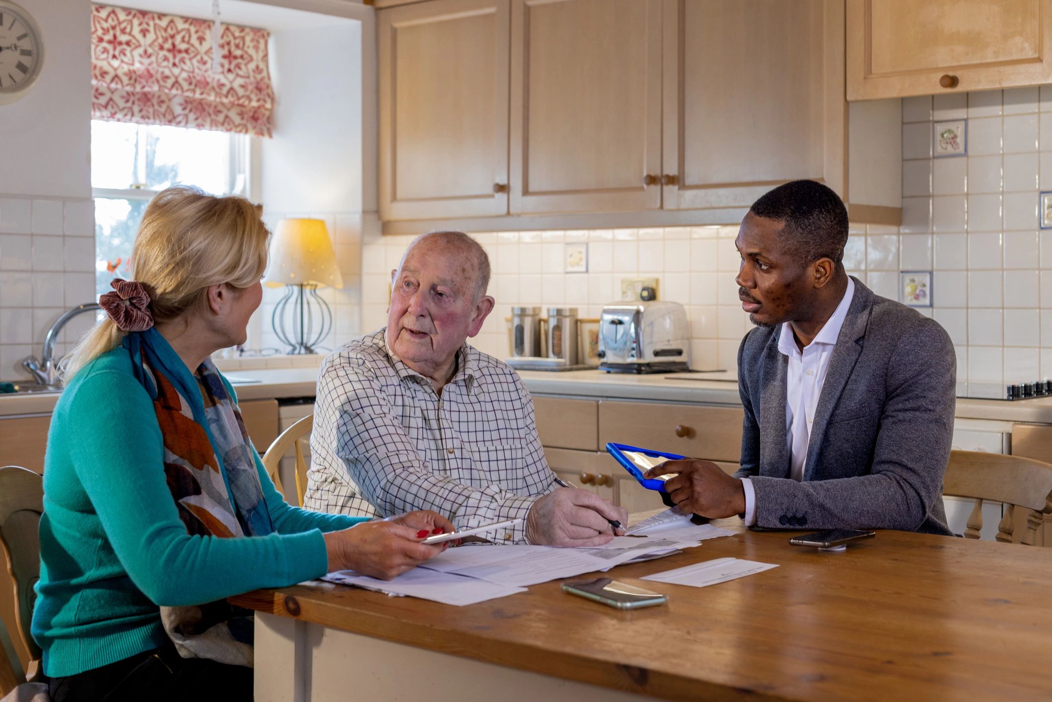 Clients reviewing documents during a real estate closing meeting