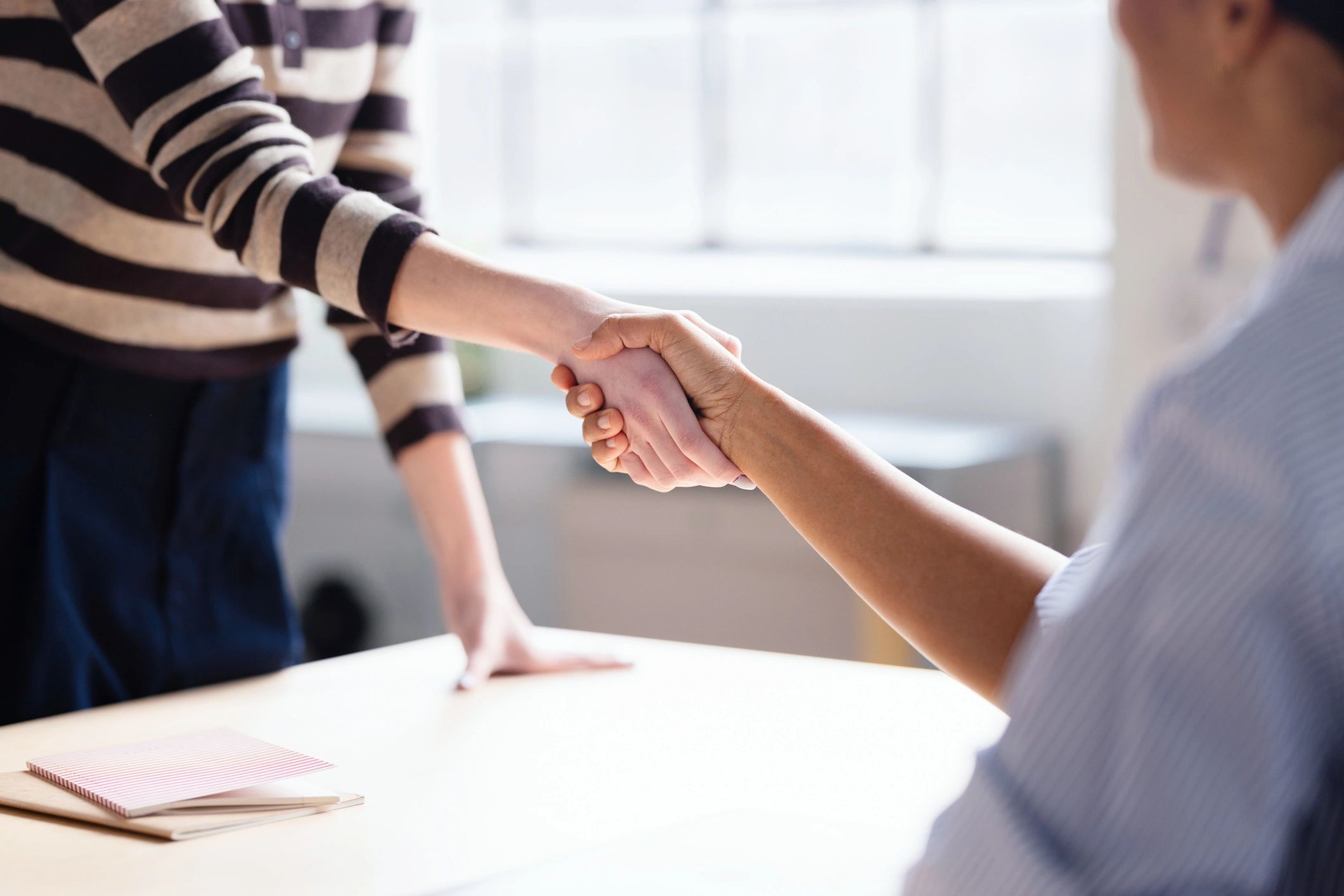 Professional handshake representing a successful commercial transaction
